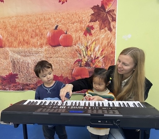 Young children exploring the keyboard in a preschool piano class
